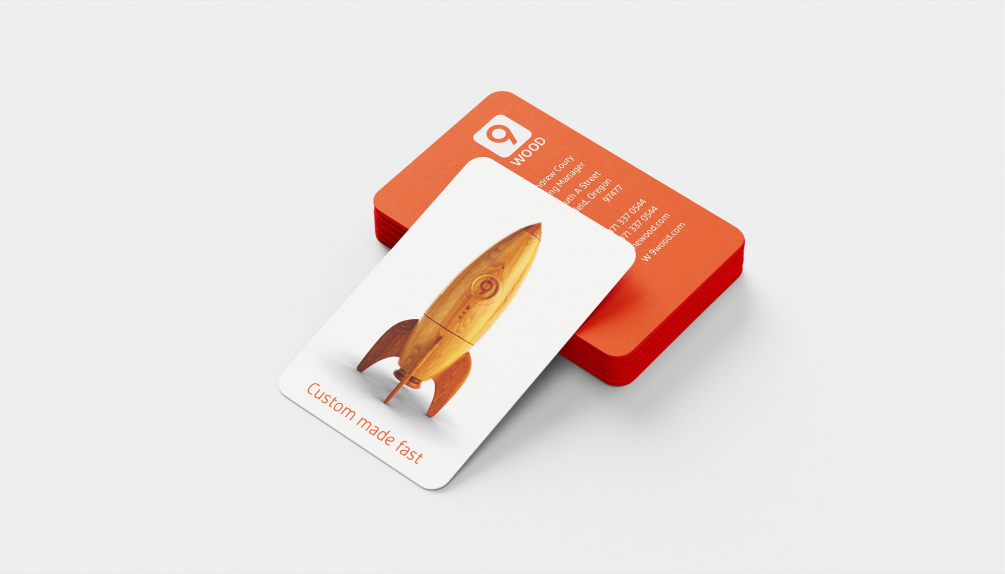 9Wood business cards: orange reverse with the 9 logo and contact details, white face with the wooden rocket and Custom made fast set on a curve