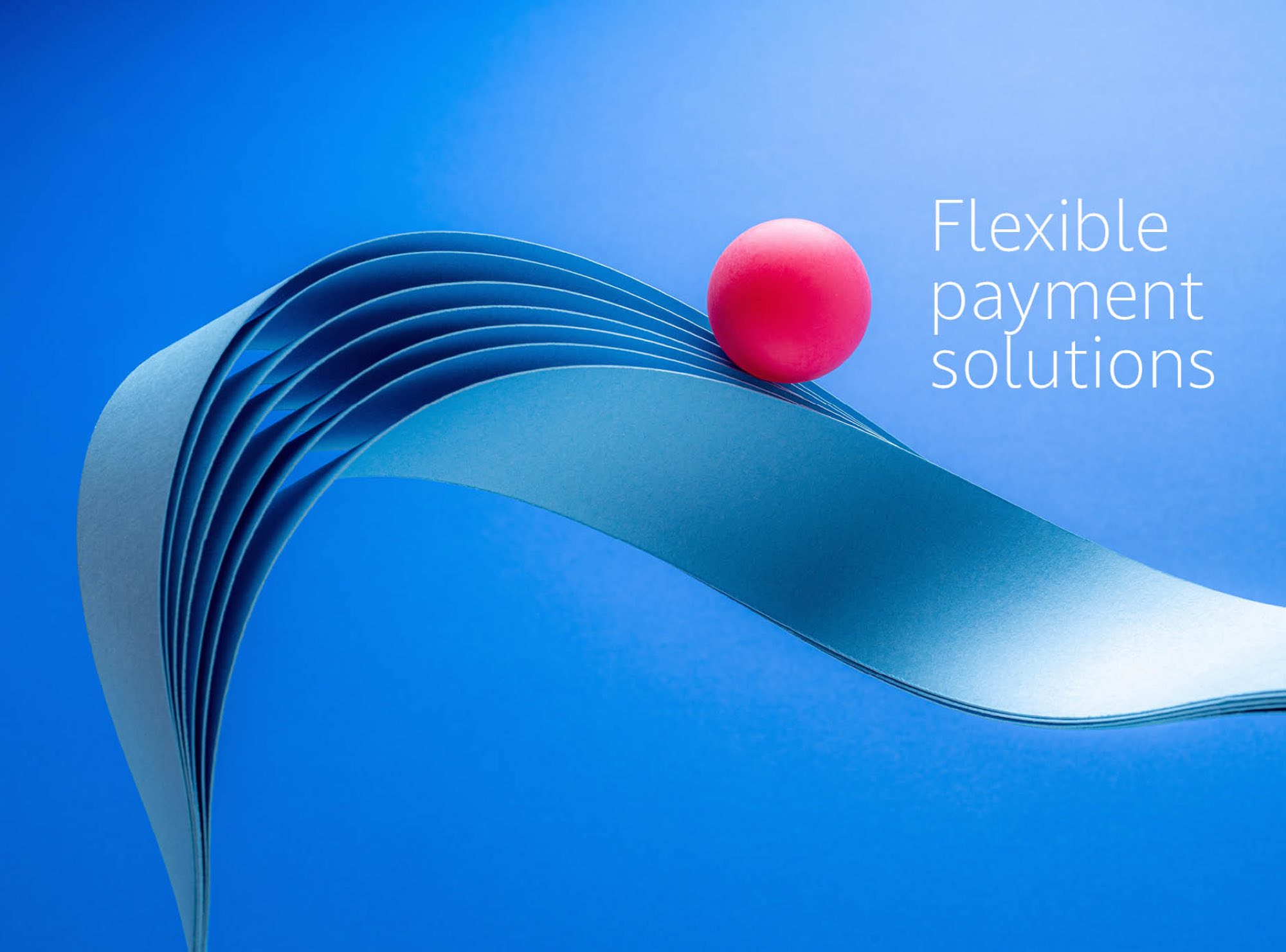 A ribbon of blue paper curving across a blue ground with a pink sphere balanced on its crest, beside the line “Flexible payment solutions”